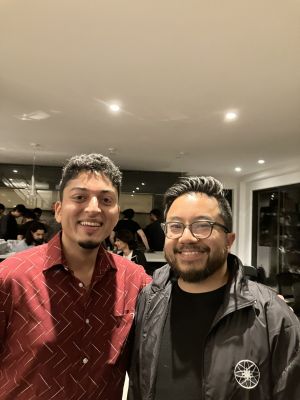 Garry Tan, CEO of YC (right) rocks the Dyson Sphere Maintenance windbreaker, a prominent e/acc merch wearable, with fellow accelerationist Rohan Pandey at the AGI House meetup in September of 2023